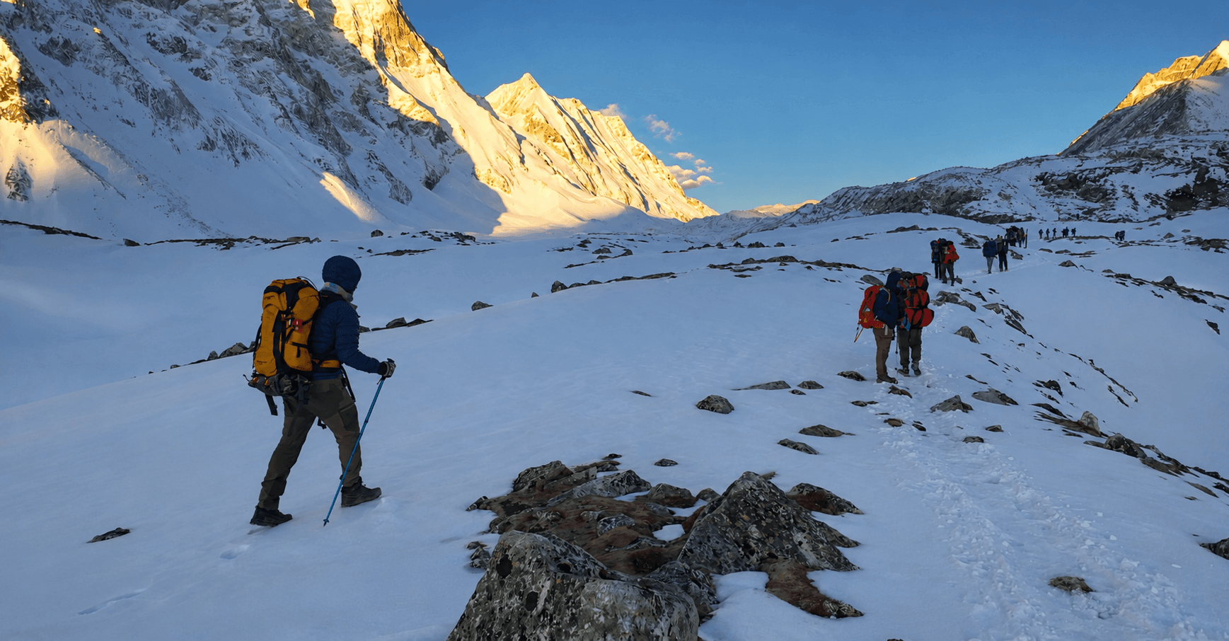 Trekkers crossing the snowy Larkya La Pass during the Manaslu Circuit Trek with Thrill Himalaya Treks.
