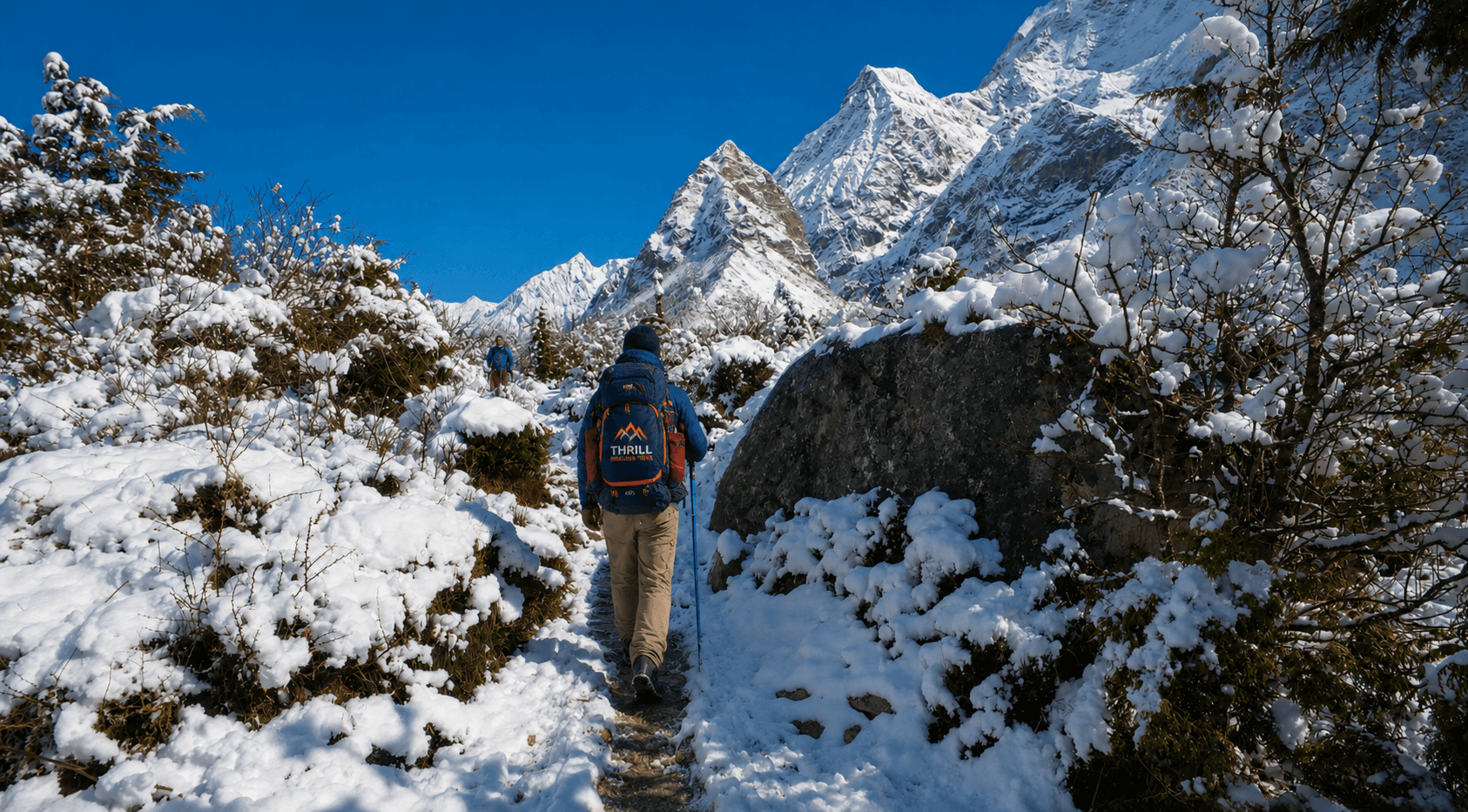 Trekker hiking a snowy section of the Manaslu Circuit Trek with Thrill Himalaya Treks in the Nepal Himalayas.