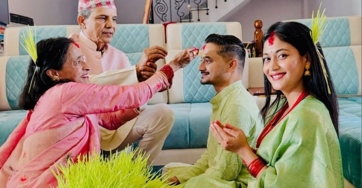 Elders applying red tika and jamara to younger family members during the Dashain festival in Nepal