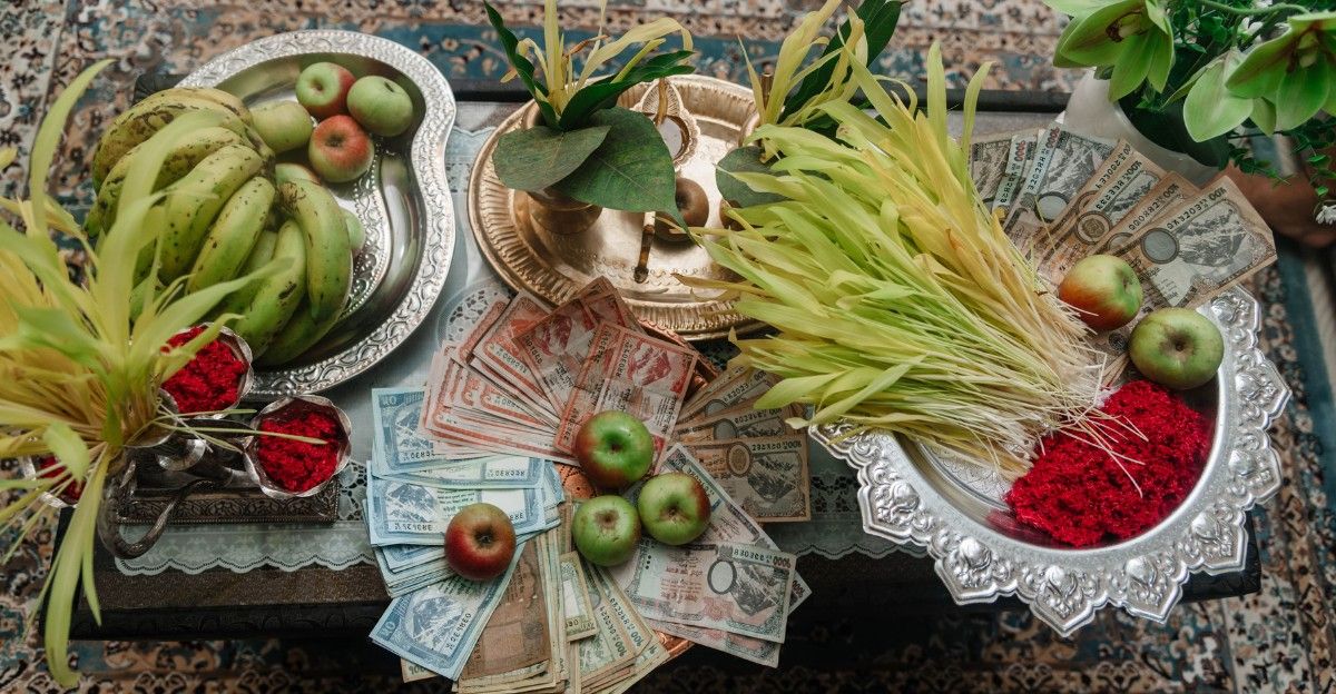 Traditional Dashain ritual plate arranged with red tika powder, yellow jamara shoots, fruits, and sacred offerings in Nepal