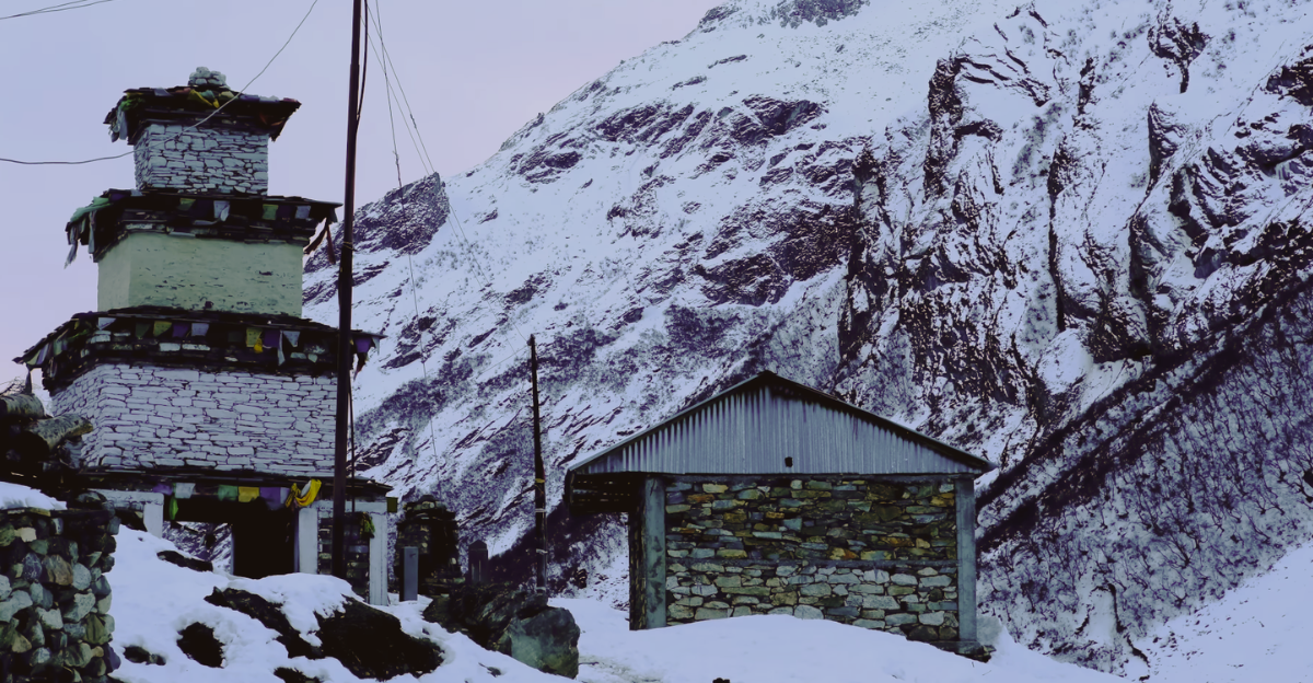 A rustic walking route framed by stone mountain houses in a high-altitude Nepalese settlement
