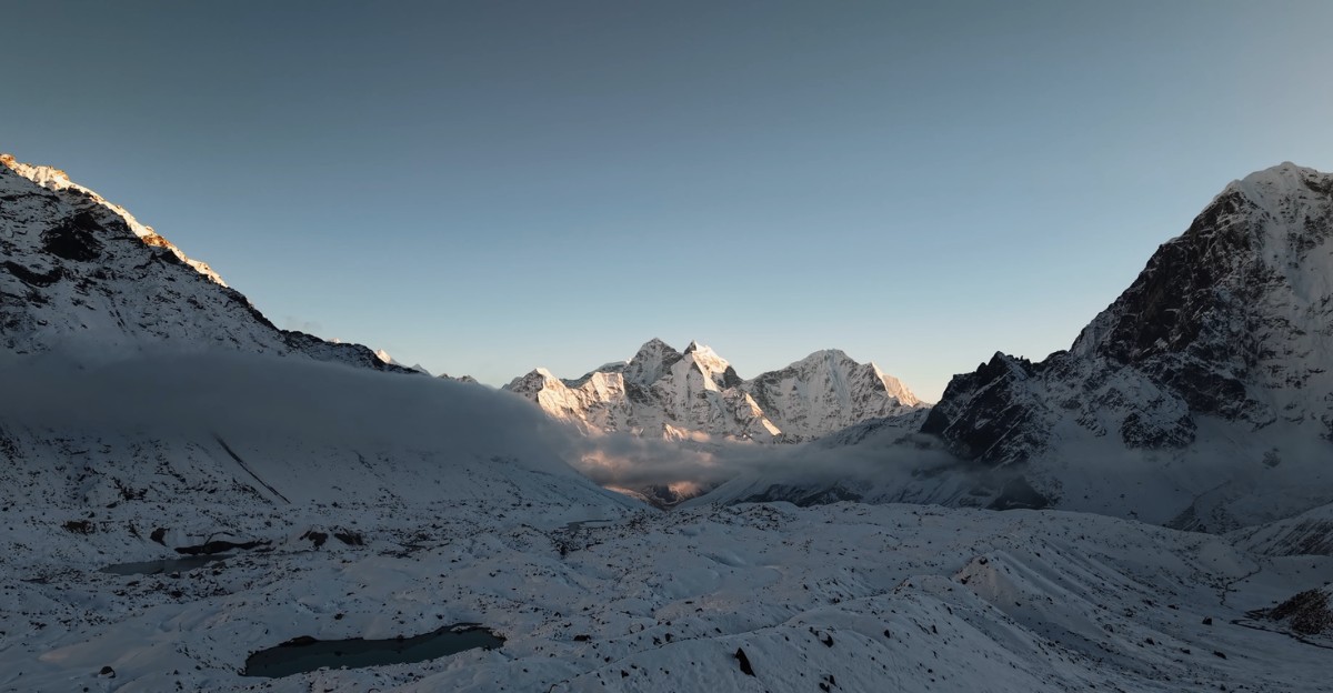 Crystal-clear panoramic view of snow-capped Himalayan peaks, including Ama Dablam, from the Everest Base Camp trekking route.