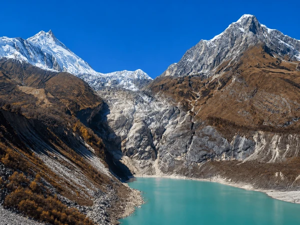 Trekkers crossing the snow-covered Larkya La Pass at 5,106 meters during the 14 days Manaslu Circuit Trek in Nepal